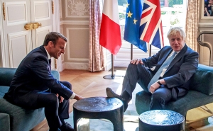 Boris Johnson Puts His Foot Up on a Table During His Meeting with President Macron