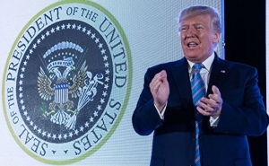 Trump Speaks Before Presidential Seal Doctored with Symbols of Russia and Golf